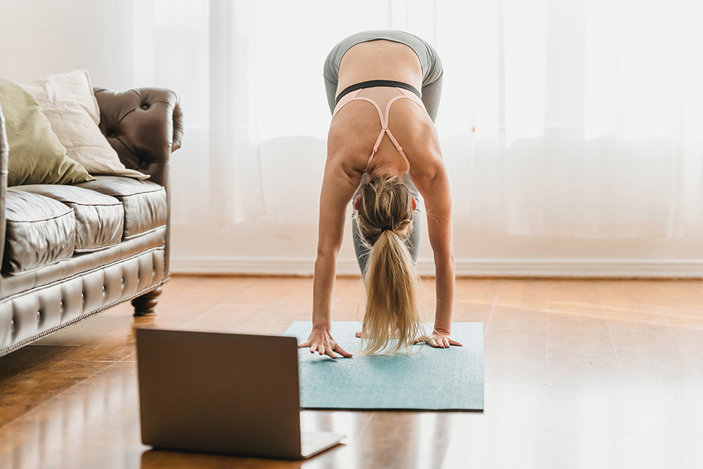 Image of a lady taking an online yoga class